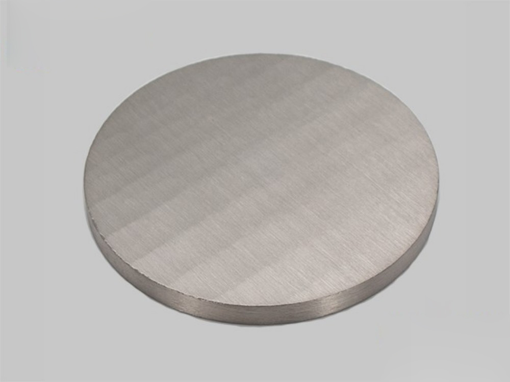 a circular metal object with a white background