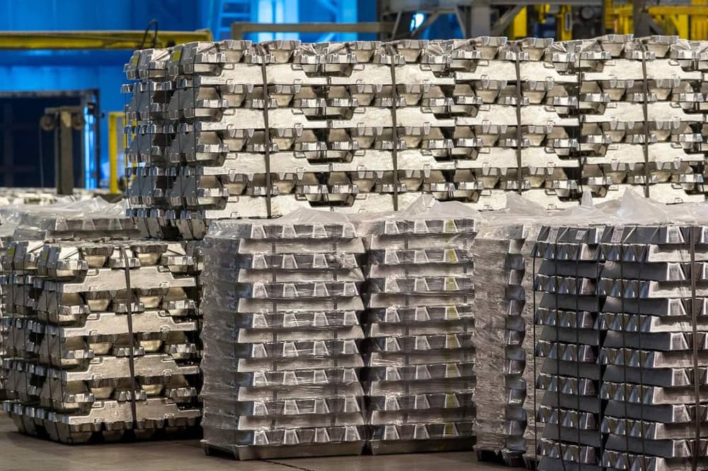 High-quality titanium alloy ingots stacked in industrial warehouse for aerospace and manufacturing applications.